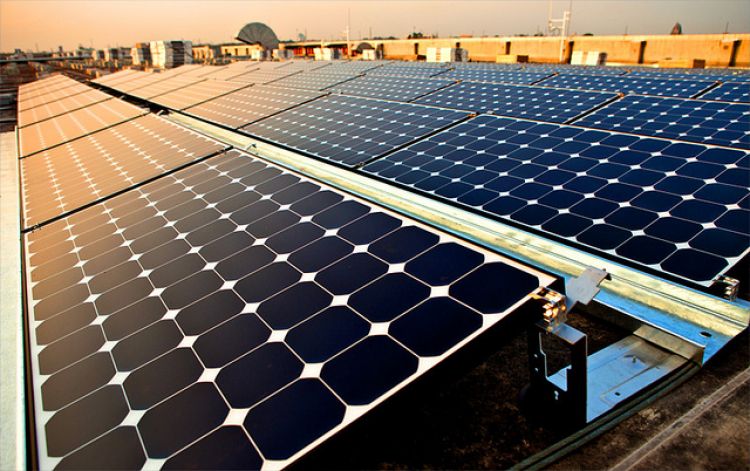 up close image of solar panels against a setting sun